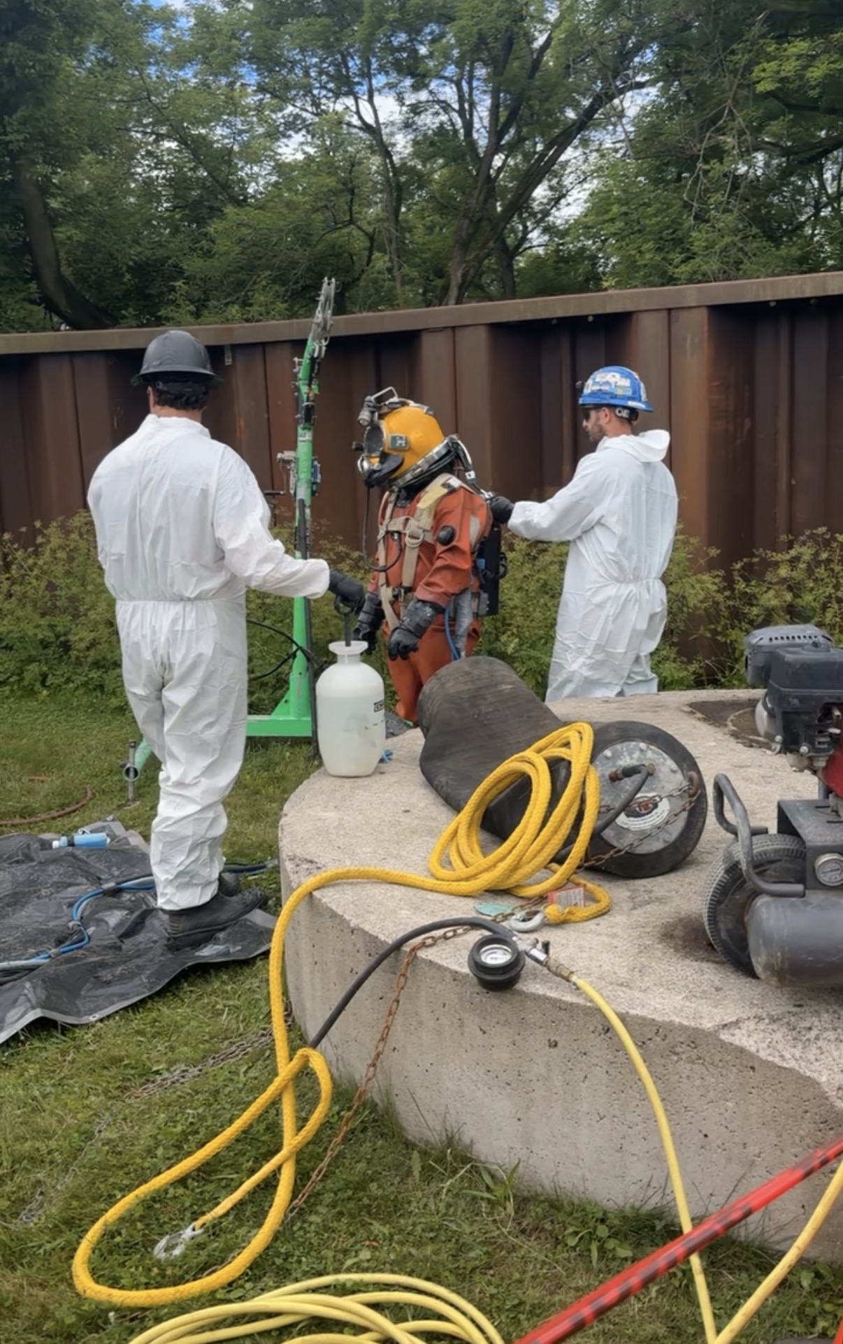Specialized confined-space or diving support operation at a wastewater facility.