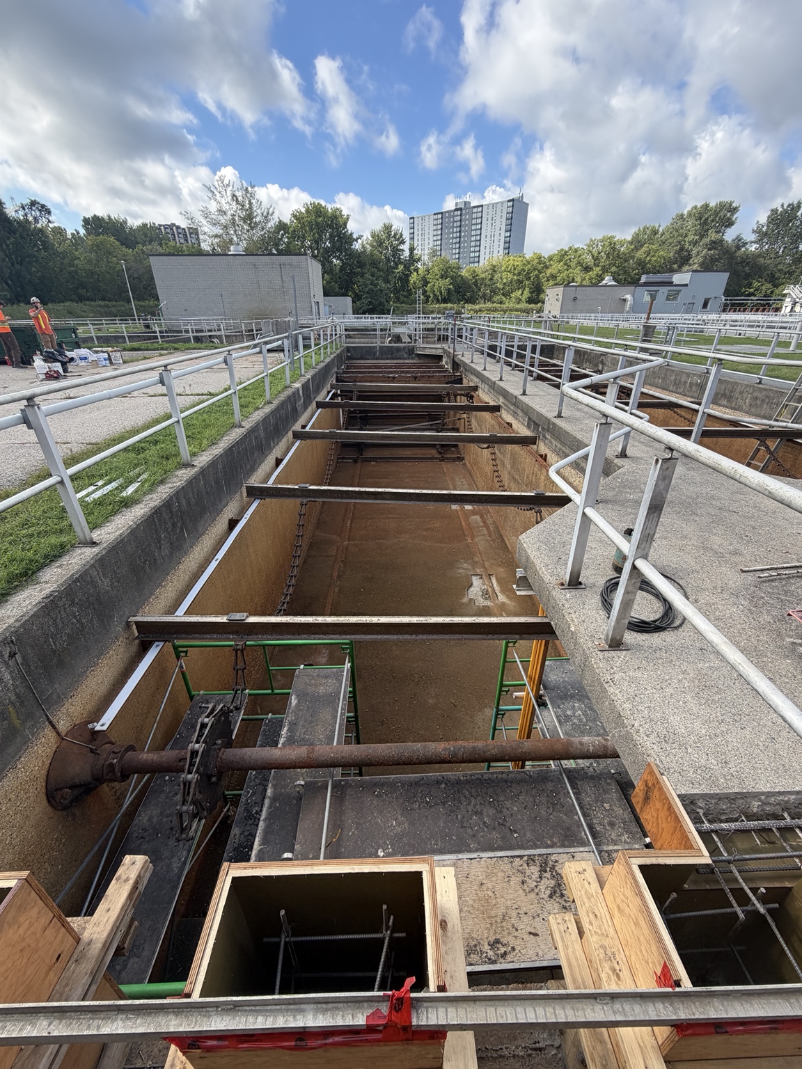 Wastewater tank undergoing maintenance with exposed structure.