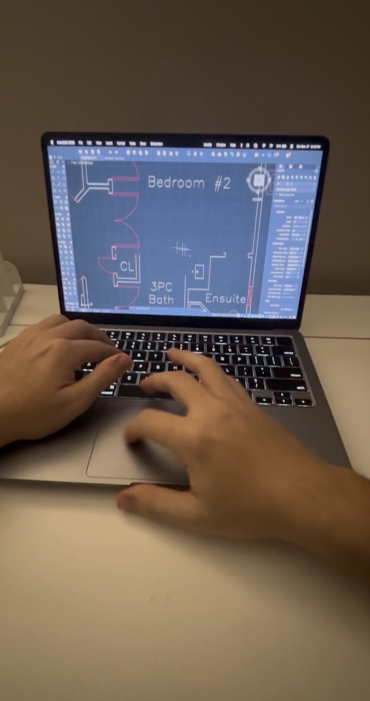 Laptop displaying CAD drawing edits.